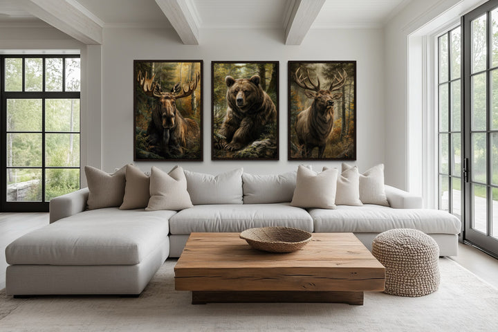 Set of 3 framed canvas paintings featuring a moose, bear, and elk in a forest setting.