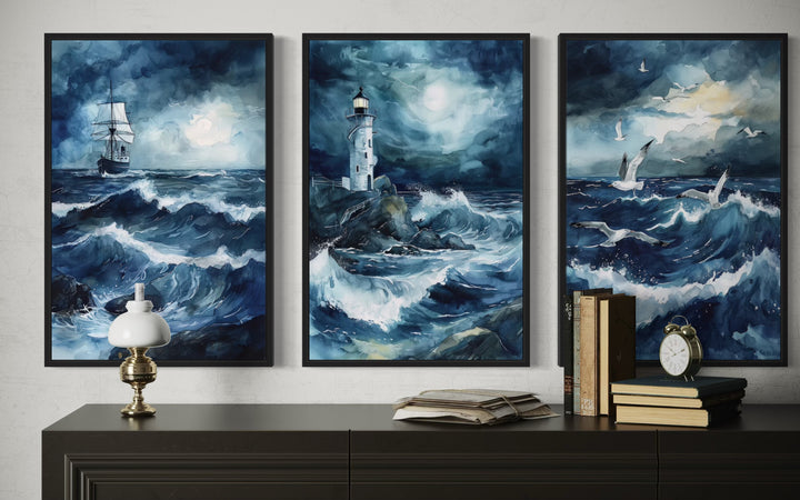 Set of 3 framed canvas prints featuring a lighthouse, sail ship, and seagulls in a stormy ocean.