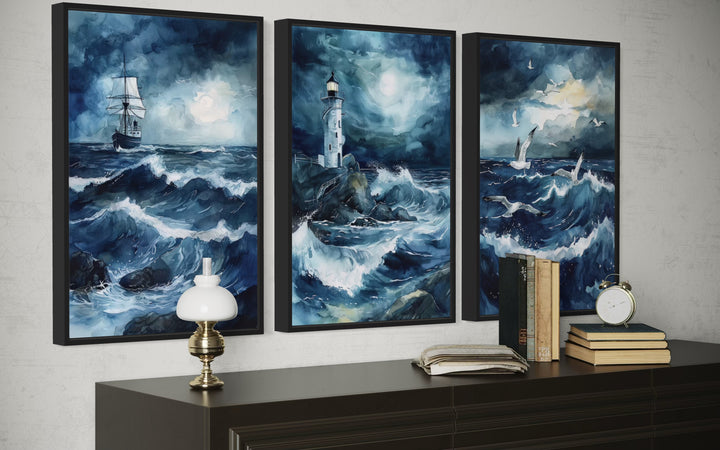Set of 3 framed canvas prints featuring a ship, lighthouse, and seagulls in a stormy blue ocean.