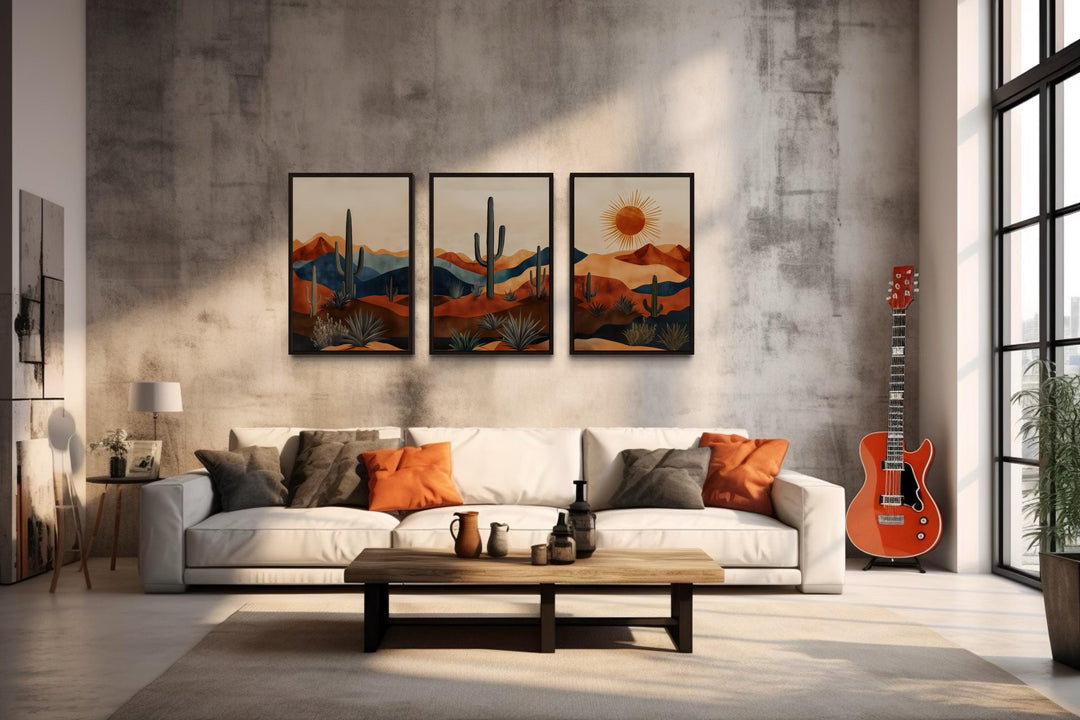 Set of 3 mid-century modern Arizona desert wall art prints with saguaro cacti and sun above a sofa.