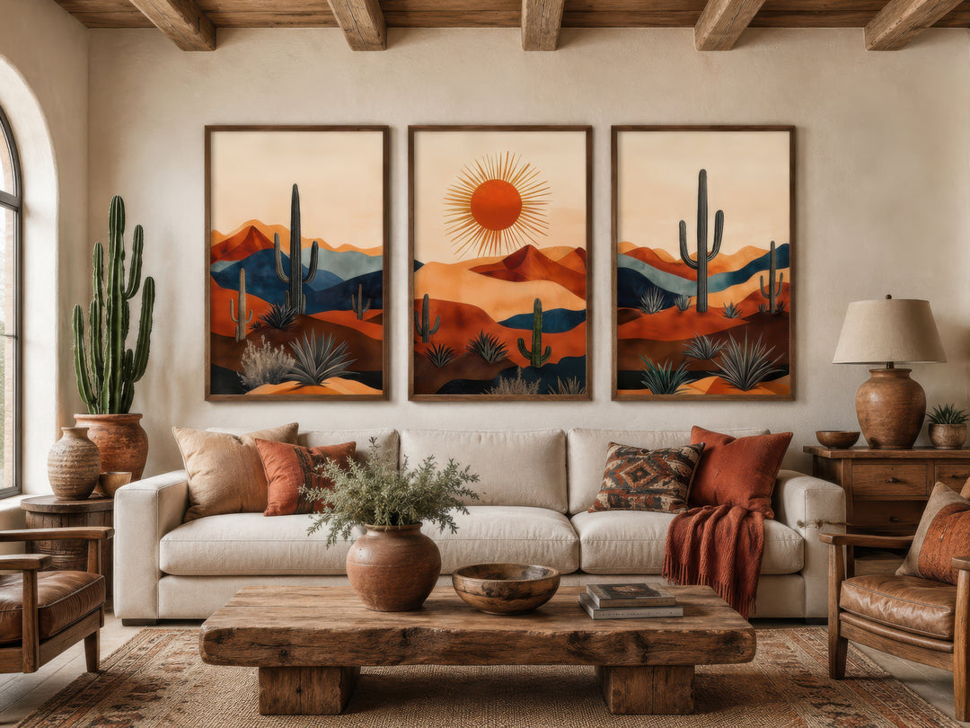 Set of 3 mid-century modern Arizona desert wall art prints with saguaro cacti and a sun over a sofa.