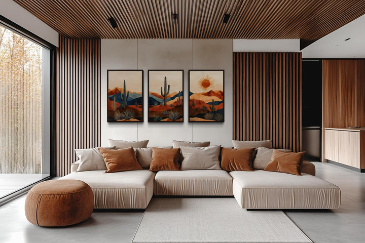 Set of 3 mid-century modern Arizona desert wall art prints with saguaro cacti and a sun over a sofa.