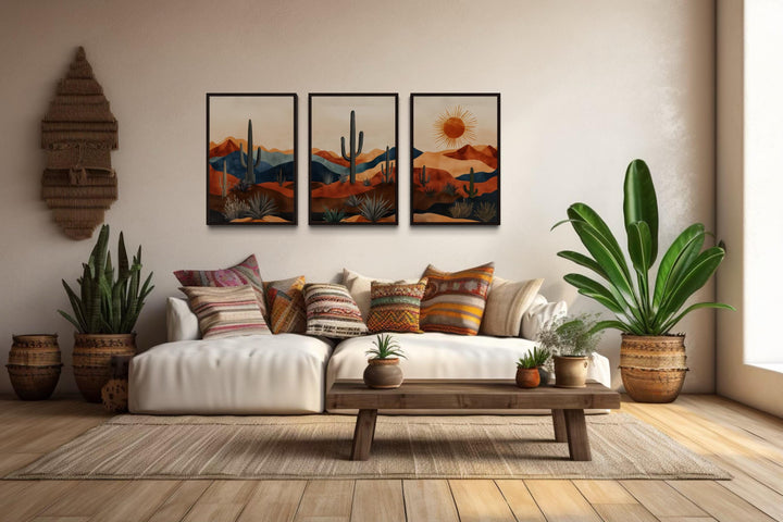 Set of 3 mid-century modern Arizona desert wall art prints with saguaro cacti and a sun over a sofa.