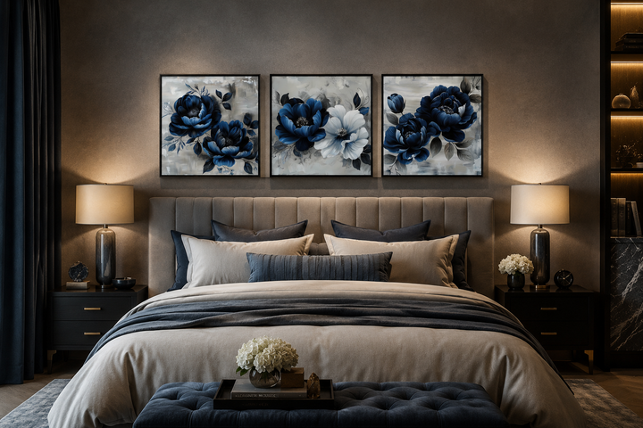 Set of 3 navy blue and gray square floral canvas prints displayed above a bed in a modern bedroom.