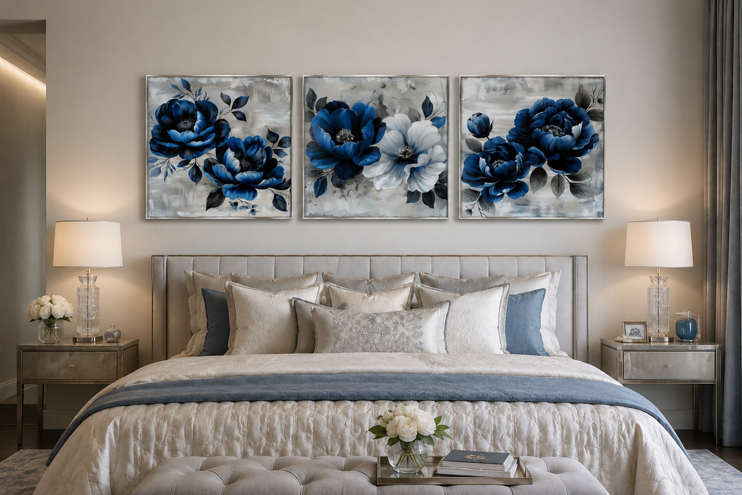 Set of 3 navy blue and gray floral square canvas prints hung above a bed in a modern bedroom.