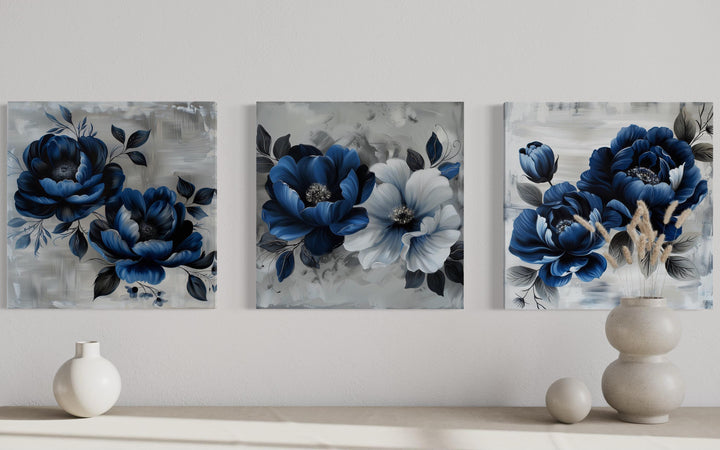 Set of 3 navy blue and gray floral square canvas prints displayed on a neutral wall.