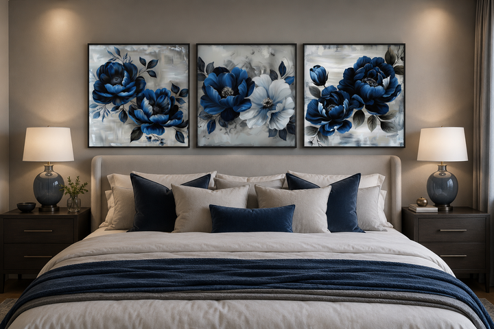 Set of 3 navy blue and gray floral square canvas prints hung above a bed with matching bedding.