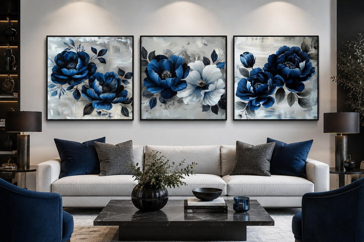 Set of 3 navy blue and gray floral square wall art prints displayed above a white sofa.