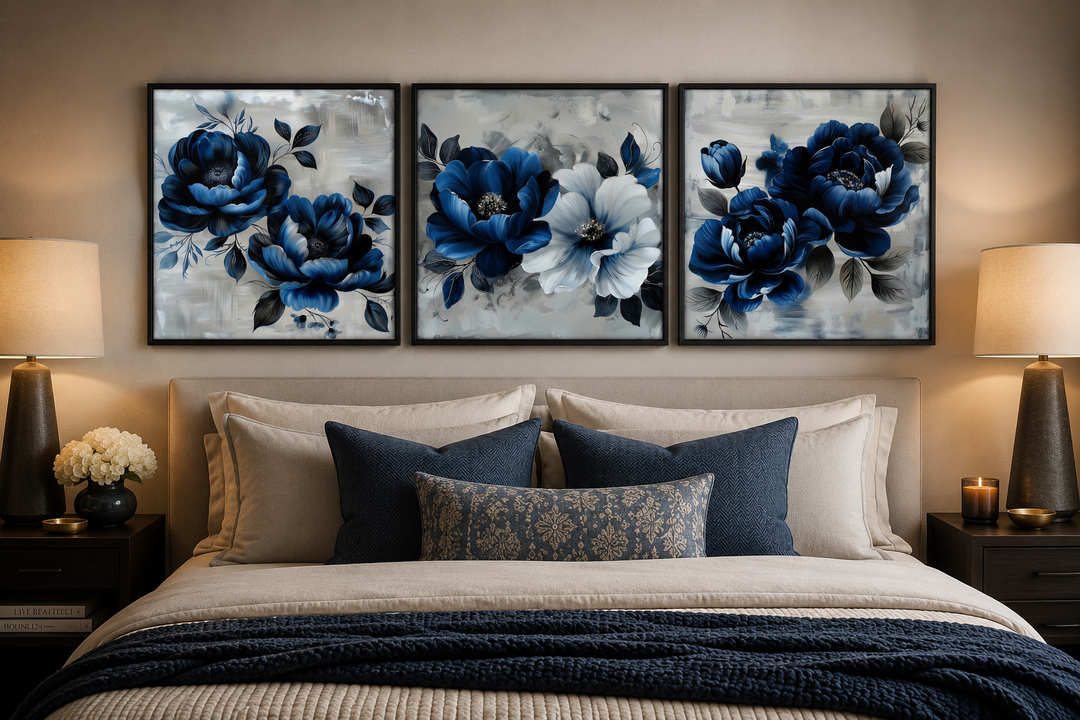 Set of 3 navy blue and gray floral square wall art prints hanging above a bed in a modern bedroom.
