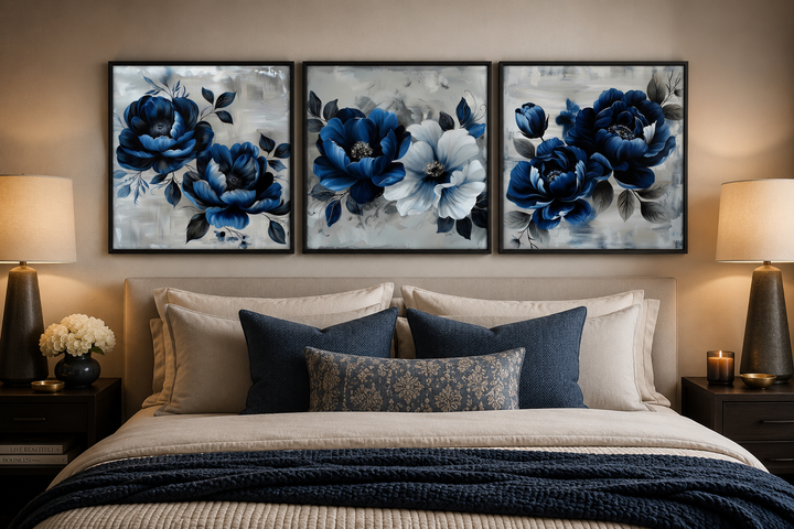 Set of 3 navy blue and gray floral square wall art prints hanging above a bed in a modern bedroom.
