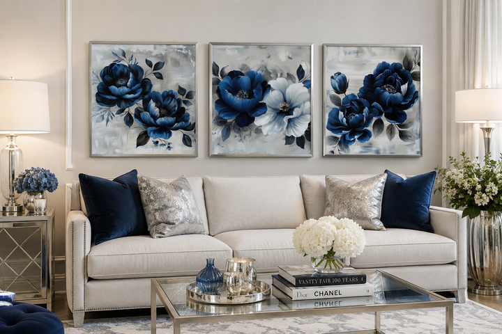 Set of 3 square navy blue and gray floral canvas prints hanging above a white sofa.