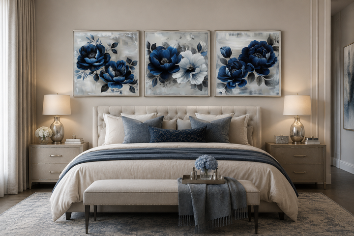 Set of 3 navy blue and gray floral square wall art prints hanging above a bed in a modern bedroom.