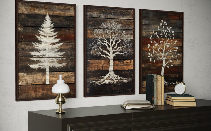 Set of three rustic canvas prints featuring white pine, oak, and birch trees on dark wood planks.