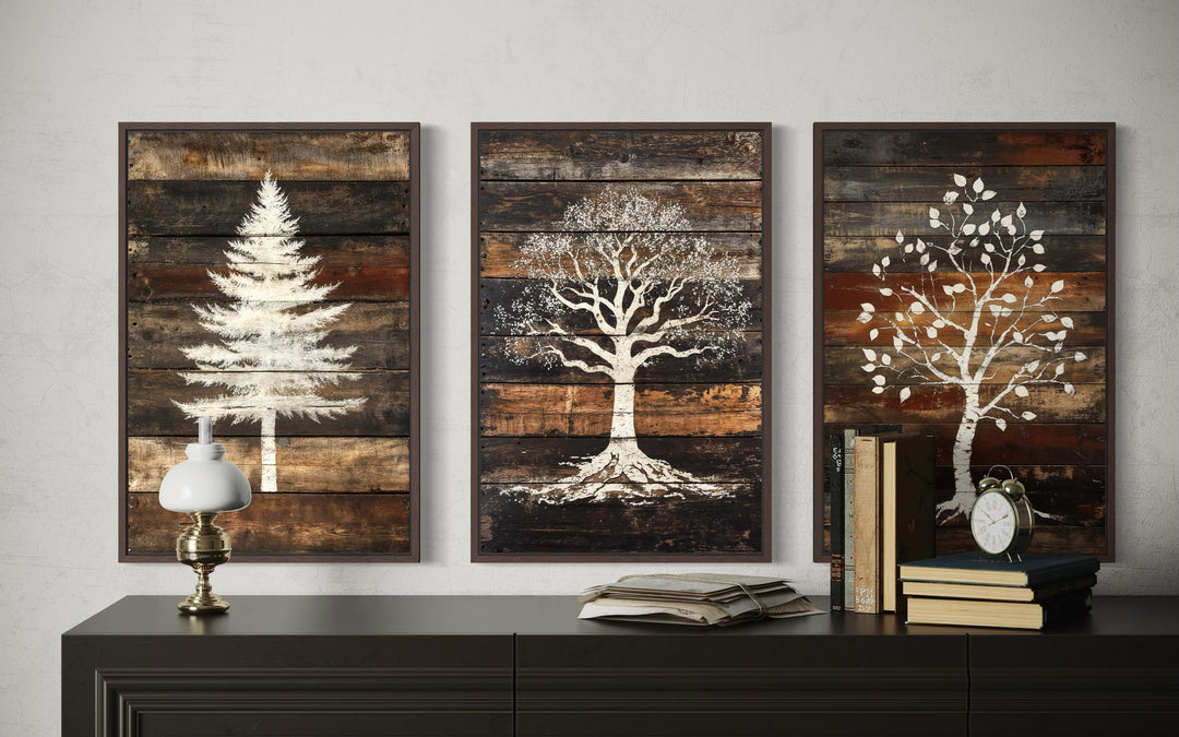 Set of 3 rustic pine, oak, and birch tree silhouettes on textured wood plank canvas wall art.