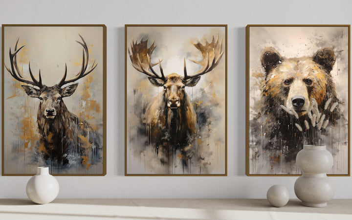Set of 3 framed wildlife canvas prints featuring an elk, moose, and bear in a rustic painted style.