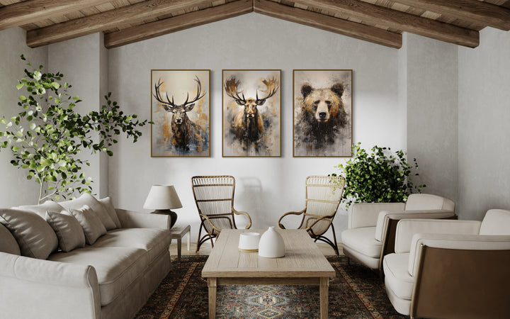 Set of 3 framed wildlife canvas prints featuring a bear, moose, and elk in a rustic living room.