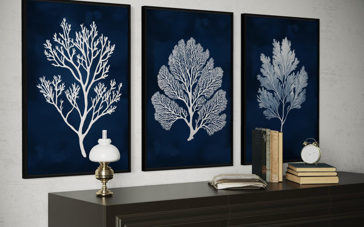 Set of three vertical navy and white sea coral nautical canvas wall art panels.