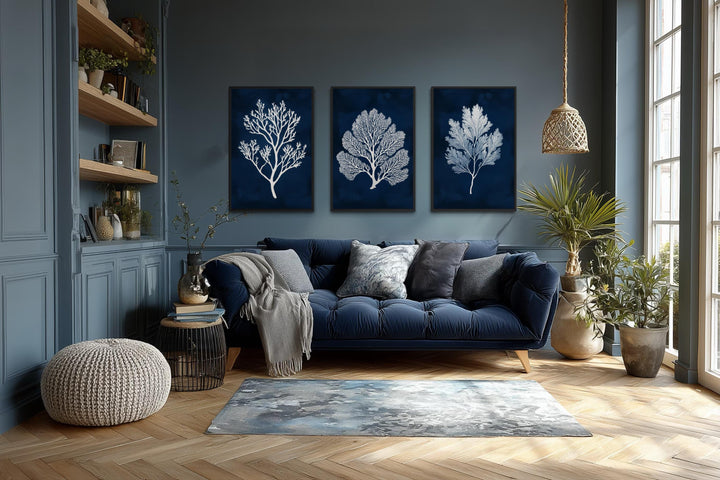 Set of three nautical canvas wall art panels featuring white sea corals on a deep navy background.
