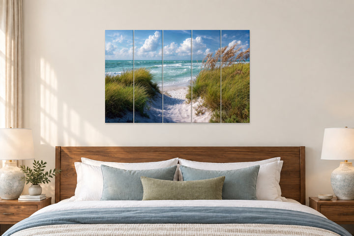 5-piece coastal canvas wall art featuring a beach dune path leading to the ocean above a bed.
