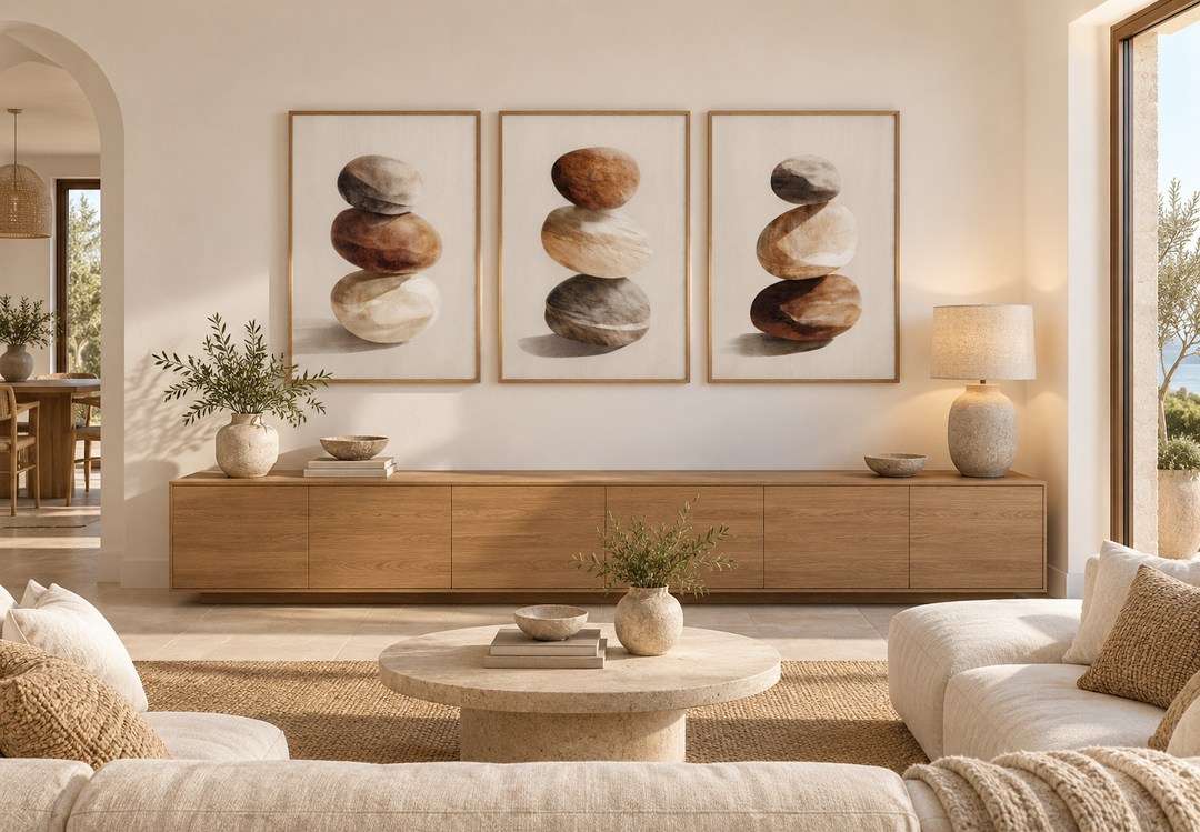 Set of 3 minimalist wall art prints featuring calming neutral stacked stones in a modern living room.