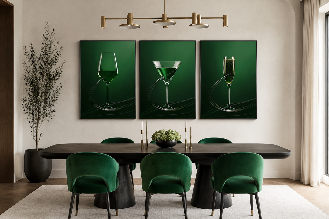 Three framed emerald green canvases of a wine glass, martini, and champagne flute in a dining room.