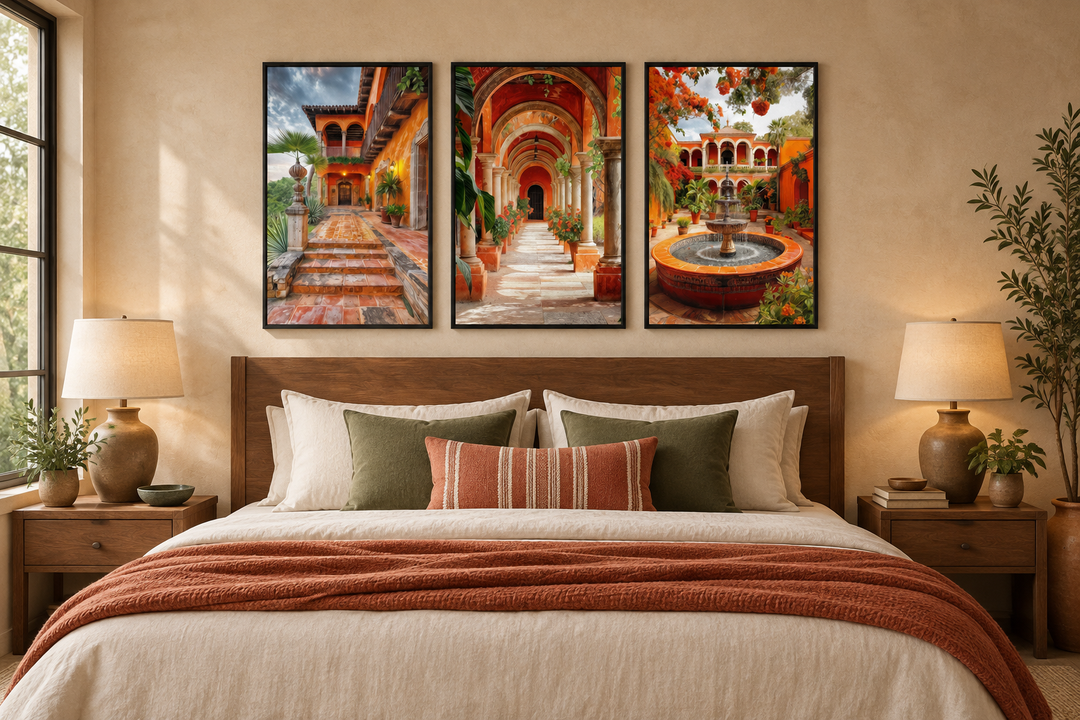 Set of three framed canvas prints featuring Mexican hacienda courtyards above a bed.