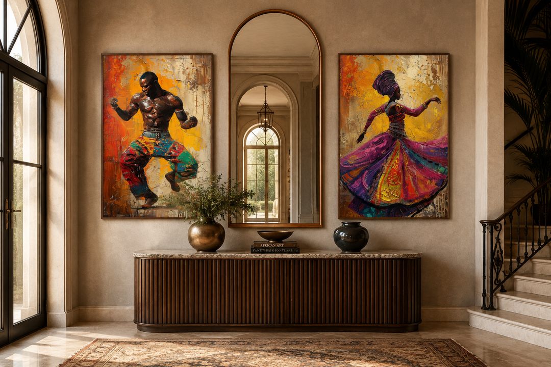 Two framed canvas paintings of an African man and woman dancing, flanking an arched mirror.