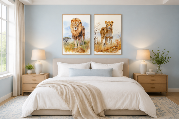 Set of 2 lion and lioness watercolor framed canvas wall art hanging above a bed in a bedroom.
