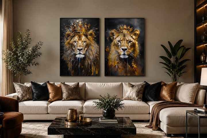 Set of two framed canvas prints featuring a lion and lioness wearing gold crowns above a sofa.