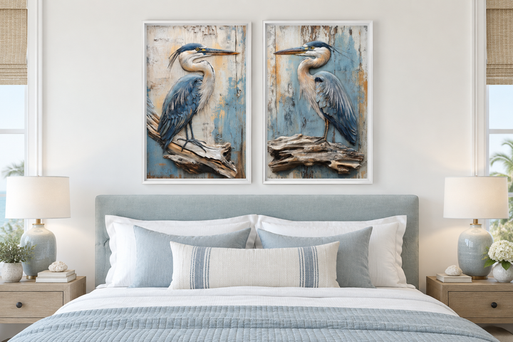 Set of 2 rustic blue herons on driftwood framed canvas wall art hanging above a bed.
