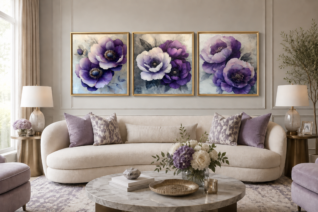 Set of three purple floral canvas prints in gold frames above a cream sofa in a modern living room.