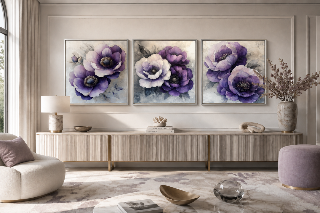 Set of three purple floral canvas prints in silver frames above a modern sideboard.