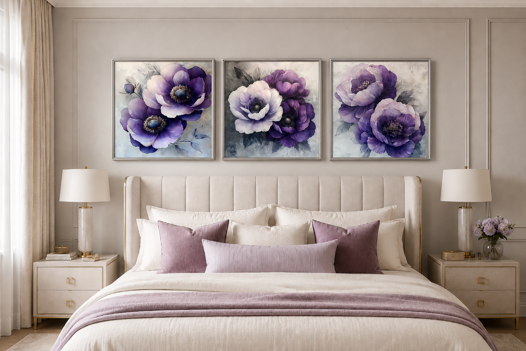 Set of three purple floral canvas prints in silver frames hanging above a bed in a modern bedroom.