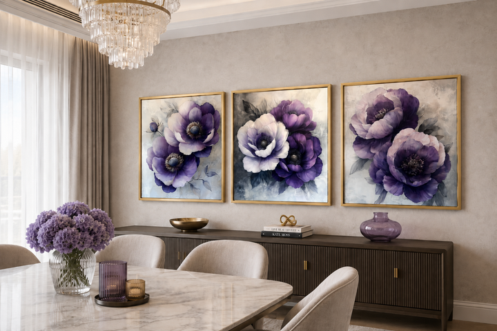 Set of three purple floral canvas prints with gold frames above a dark wood sideboard.