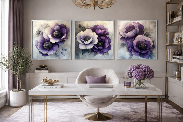 Set of three purple floral canvas prints in a modern office with a marble desk and velvet chair.
