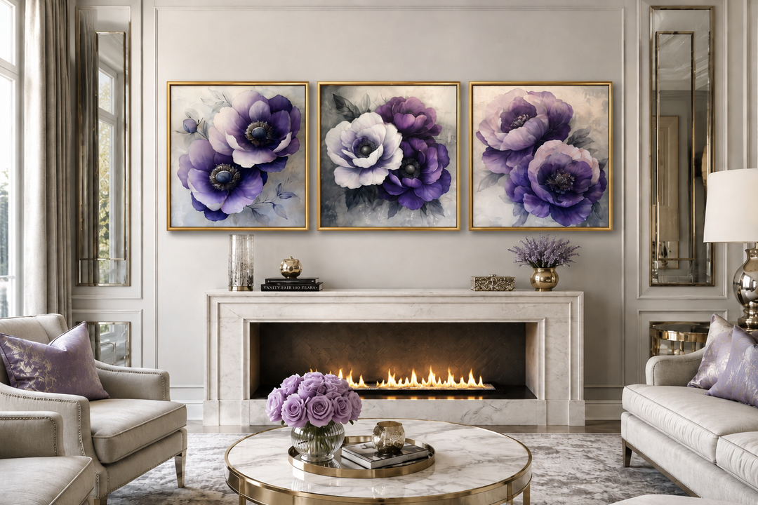 Set of three framed purple floral canvas prints displayed above a marble fireplace in a living room.