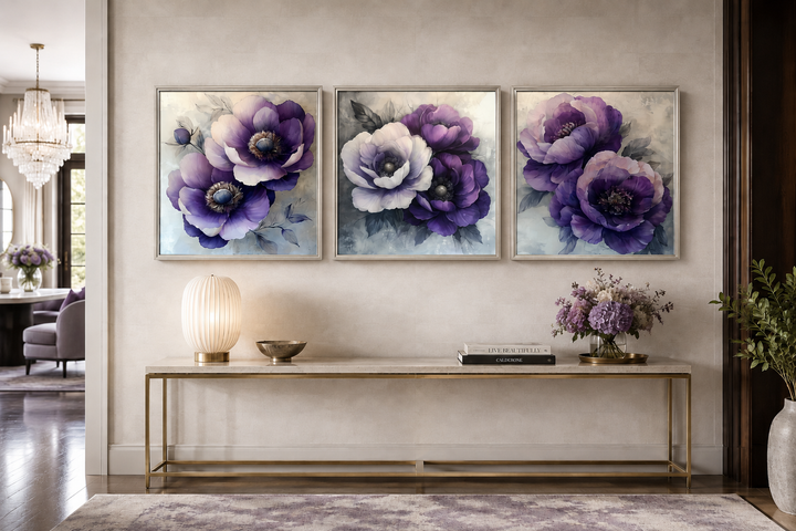 Set of three framed purple floral canvas prints displayed above a console table in a living room.