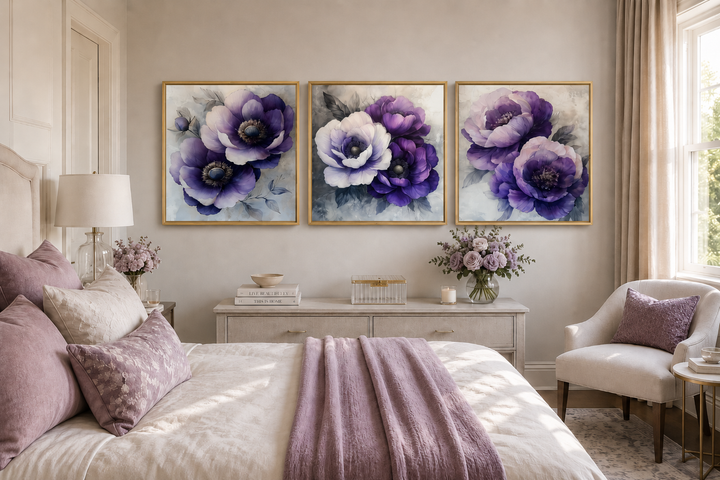 Set of three purple floral canvas prints with gold frames above a dresser in a bedroom.