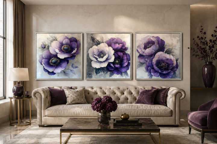 Set of three purple floral canvas prints displayed above a beige sofa in a modern living room.