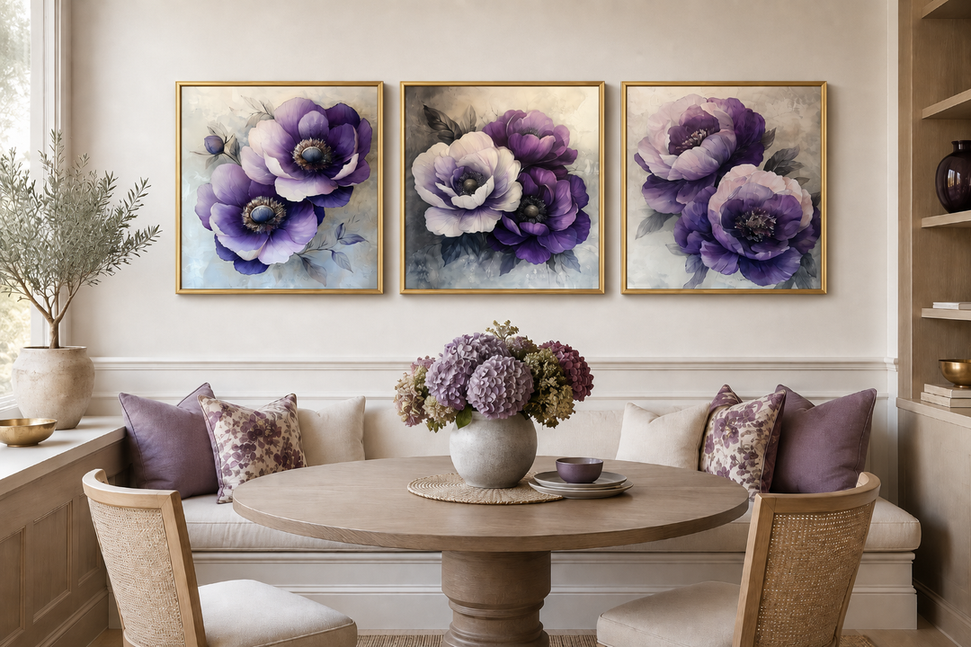 Set of three gold-framed canvas prints featuring purple and white floral blooms in a dining area.