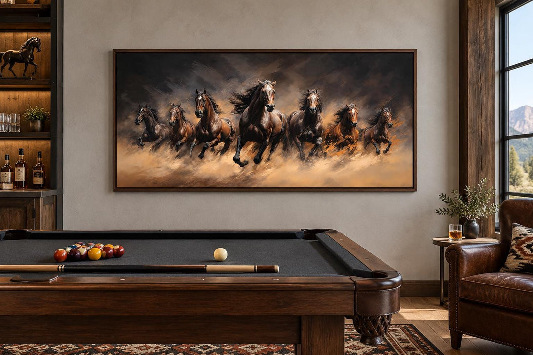 Seven Wild Horses Galloping Through Swirling Dust Framed Canvas Wall Art in a game room.