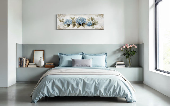 Shabby chic long horizontal canvas wall art featuring blue hydrangeas above a bed.