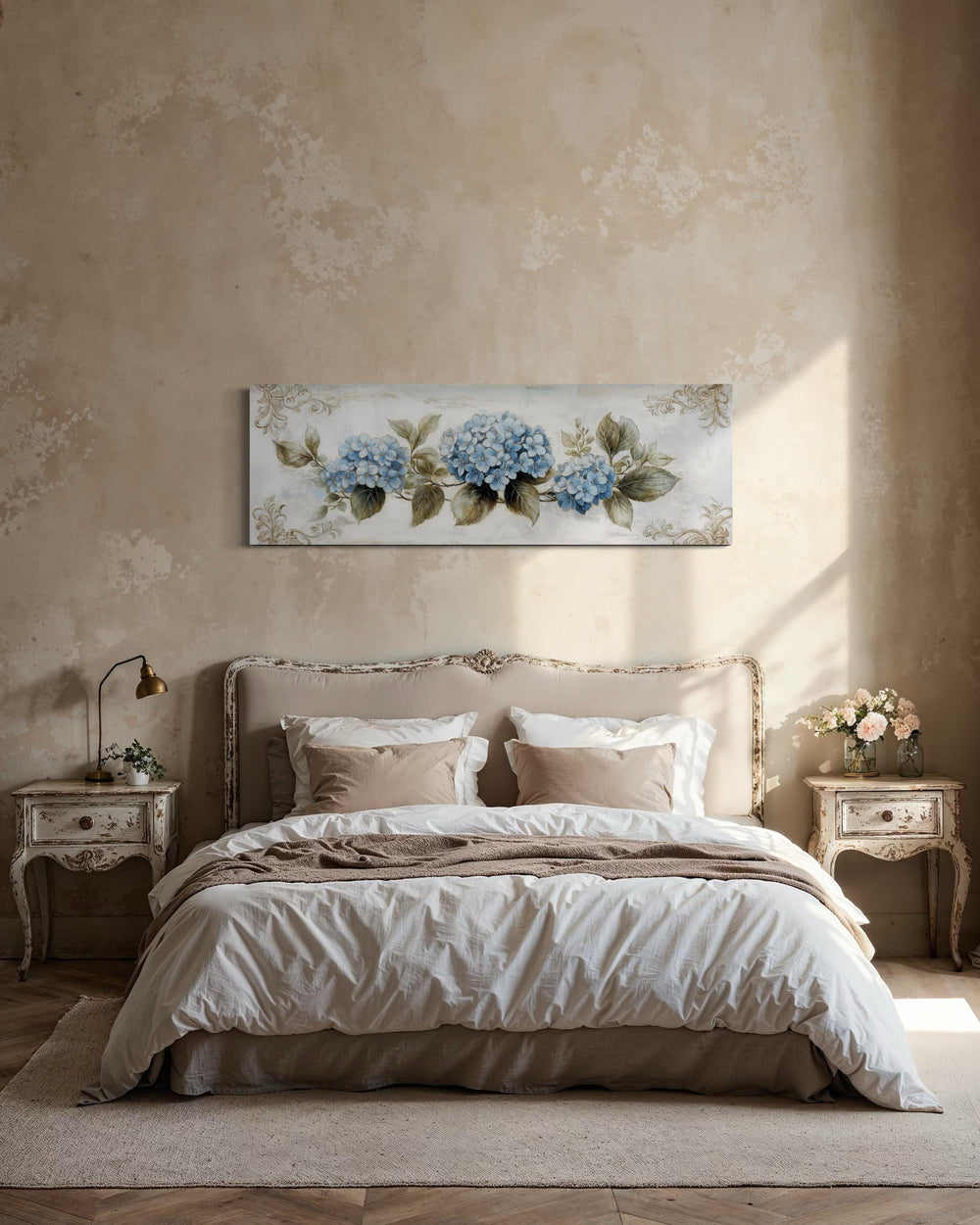 Long horizontal canvas art of blue hydrangeas hanging above a bed in a shabby chic bedroom.