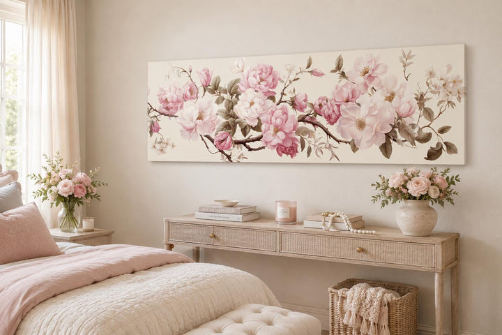 Shabby chic long horizontal wall art with pink and white flowers above a bed and console table.