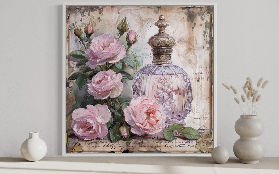 Shabby chic framed canvas wall art featuring a vintage perfume bottle and soft pink roses.