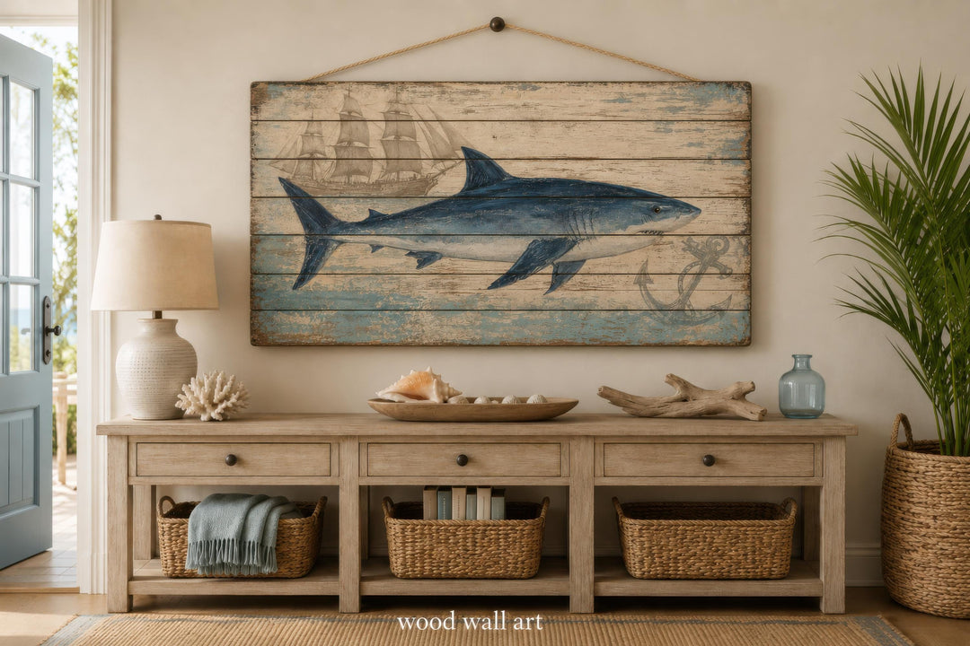 Distressed wood panel wall art featuring a blue shark, a vintage ship, and an anchor.