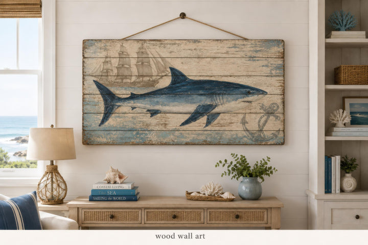 Nautical wood wall art featuring a blue shark, ship, and anchor on distressed horizontal planks.