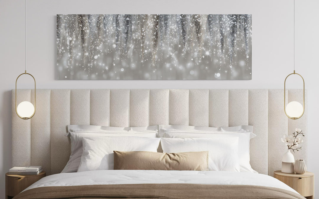 Silver beige abstract rain canvas print hanging above a modern upholstered bed with gold lighting.
