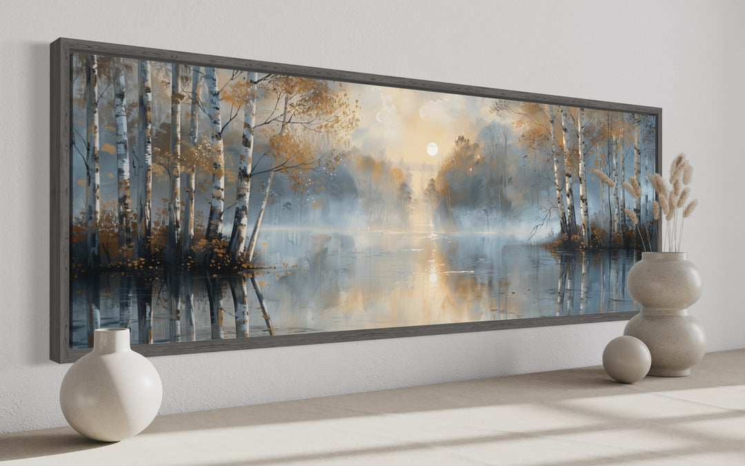 Panoramic wall art of a misty silver birch forest over a lake in a dark wood frame.