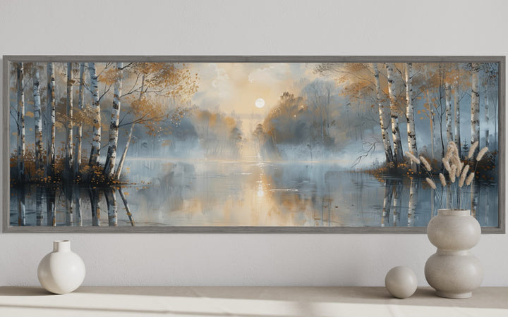 Silver birch trees forest wall art in a long horizontal frame above a console with decorative vases.